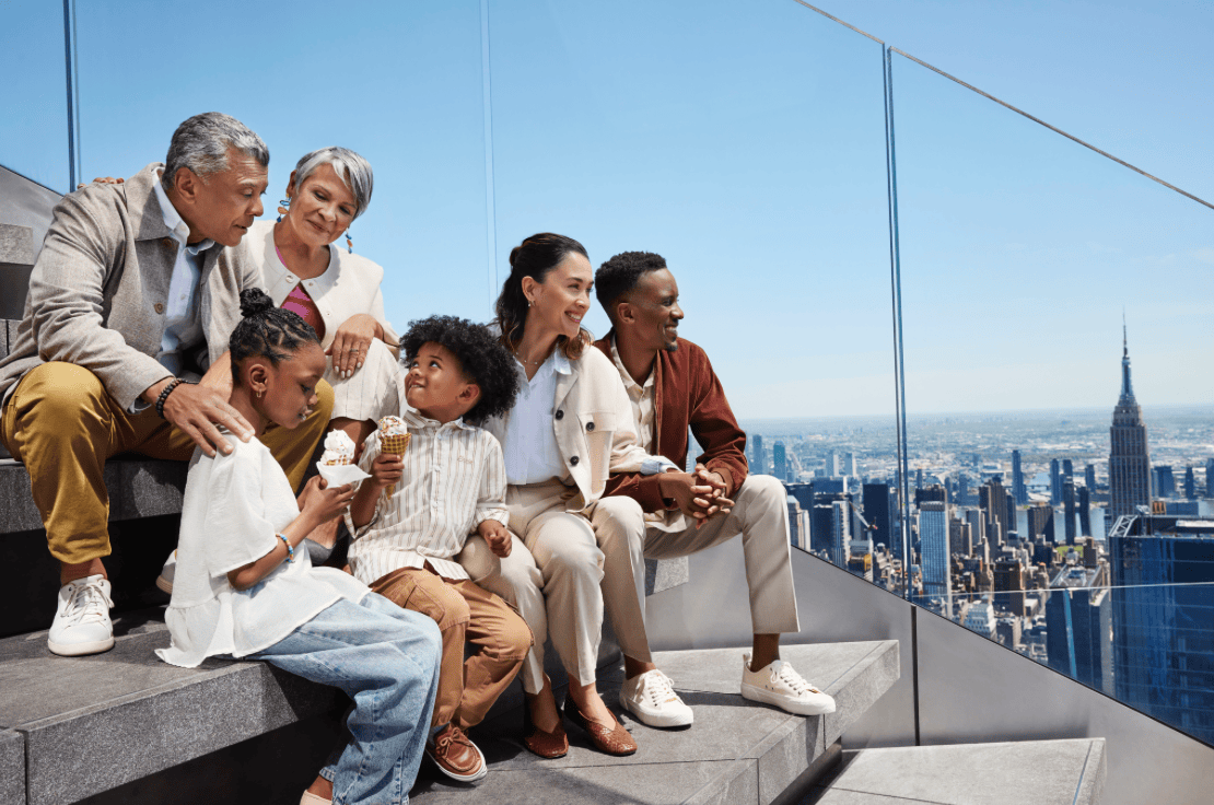 Family with ice cream sitting on the steps outside of The Edge NYC